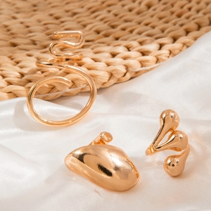 Macro detail of irregular gold ring set on silk fabric with elegant polished finish