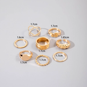 Detail view of 8-piece gold ring set showing 1.6cm to 1.7cm inner diameter measurements