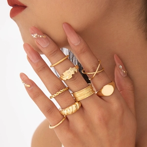 Close-up of 8-piece gold bohemian ring set featuring minimalist hollow and curved designs
