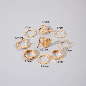 Detail showing 9pcs gold ring set with diverse hollow snake and wavy textured designs