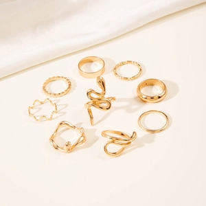 Detailed view of a 9-piece gold ring set featuring snake and geometric wave designs