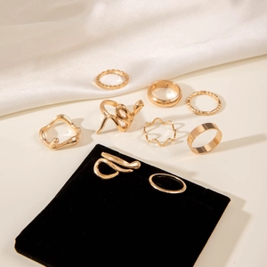 Detailed set of nine irregular golden hollow rings with smooth curved and minimalist designs