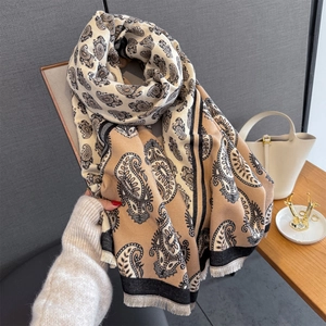 Close-up of paisley print scarf featuring elegant fringe tassels and warm cashmere blend fabric