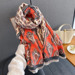 Detail of paisley pattern and soft fringe on this orange and grey autumn winter scarf