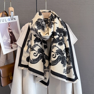Detail of floral paisley print on thick cashmere-like scarf with fringe edges
