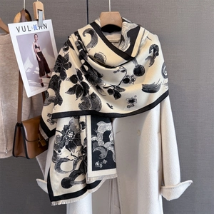Detail of peony floral print scarf featuring thick cashmere-like texture and tassel edges