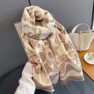 Detailed close-up of thick floral cashmere scarf with elegant fringe and art pattern