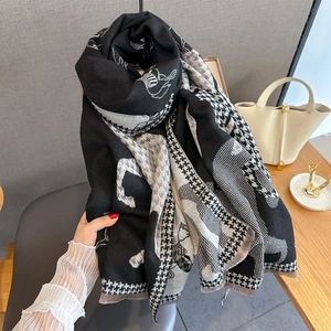 Detail of cashmere-like scarf with houndstooth horse pattern and soft fringe edges