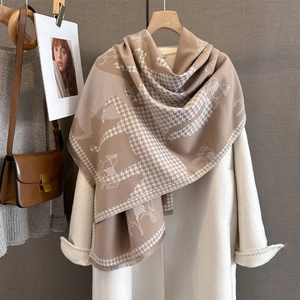 Detail of camel cashmere-feel scarf with horse print, houndstooth and fine tassels
