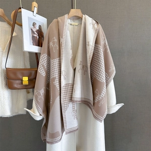 Detailed texture of thick cashmere-feel scarf with vintage horse and houndstooth pattern