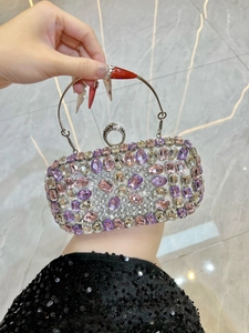 Macro shot of rectangular evening clutch with colorful rhinestones and ring lock