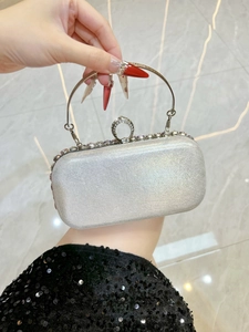 Detail of silver evening clutch with sparkling glitter and colorful rhinestones on clasp