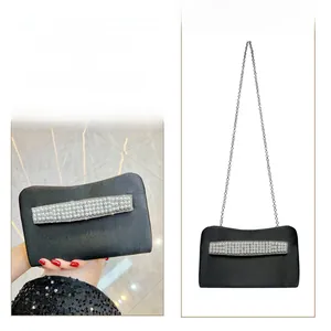 Elegant black evening clutch with white pearl strips and a detachable metal chain strap