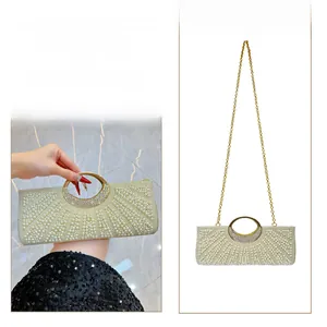 Detail of evening bag showing metal rhinestone handle and gold chain strap modes
