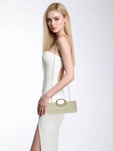 Detail of evening clutch bag with rhinestones, pearls and golden round handle