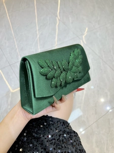 Elegant dark green satin evening clutch bag with sparkling green rhinestone leaf decoration
