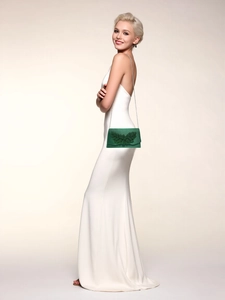 Detail of dark green evening clutch with leaf embroidery and slim silver chain strap