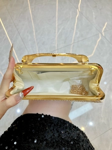 Elegant gold pleated evening clutch bag with metal handle and chain strap for women
