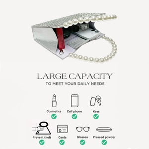 Detail showing spacious interior of rhinestone evening bag with pearl handle and accessories