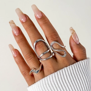 Detail of irregular silver liquid metal rings set on hand with minimalist aesthetic