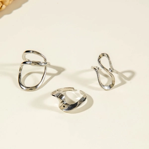 Detail of silver irregular wavy rings set with organic fluid liquid metal design