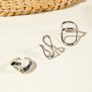 Detailed view of silver minimalist irregular hollow curved rings in a four-piece set