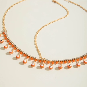 Chaîne de tête bohème dorée avec strass et pendentifs orange œil de protection