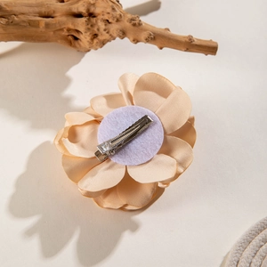 Detail of fabric rose hair clip with metal duckbill clasp and soft felt base support