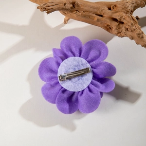 Detailed back view of purple fabric flower hair clip with silver metal alligator clip