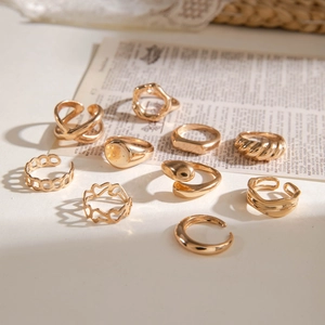 Detailed view of ten piece gold ring set featuring twist and hollow heart designs