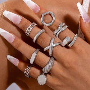 Detail of 10pcs silver alloy punk ring set with hollow twist and cross designs on hands