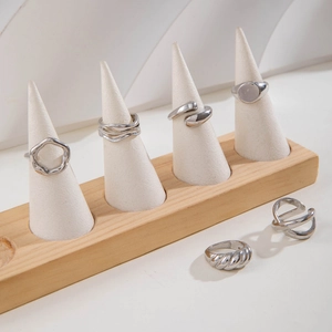 Detailed view of six silver punk style rings with twist and hollow geometric patterns
