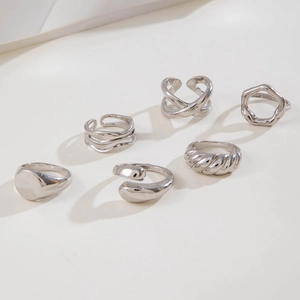 Close-up of a 6-piece silver alloy ring set featuring twisted and hollow geometric designs