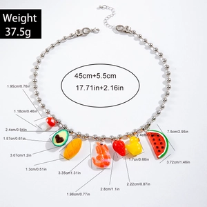 Detailed view of bohemian beaded necklace with cute avocado and mushroom charms