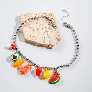 Detailed shot of bohemian beaded necklace with colorful avocado and strawberry charms