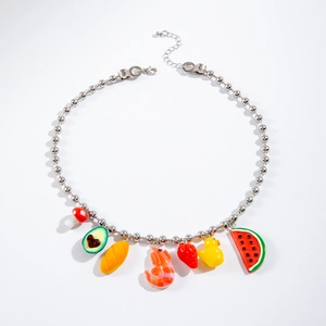Detail of beaded necklace featuring fun resin pendants like avocado, mushroom and strawberry