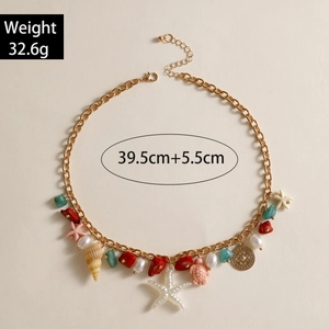 Detail of bohemian gold chain necklace with sea charms, length 39.5cm and weight 32.6g