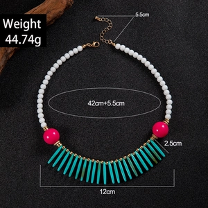 Detail of bohemian necklace with white beads and vibrant tassels including sizing info