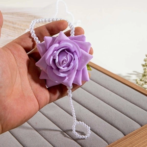 Detail of purple 3D orchid flower hand chain with elegant white pearl wrist and ring links