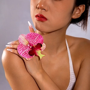 Detailed view of a 3D printed pink Phalaenopsis orchid ring with elegant pearl finger chain