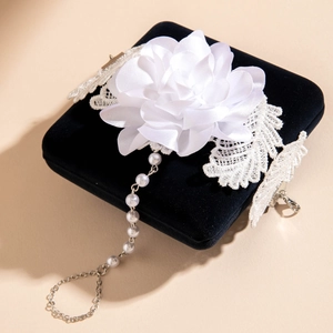 Detail of 3D printed white phalaenopsis flower ring with pearls and lace on velvet box