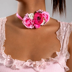 Detailed view of pink floral choker necklace featuring satin ribbons and faux roses