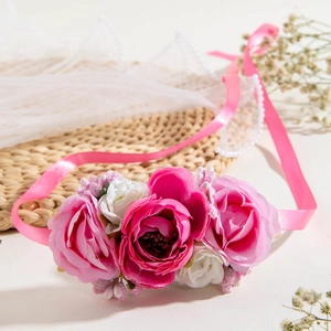 Macro view of handmade white and pink faux roses on an elegant silk ribbon floral necklace