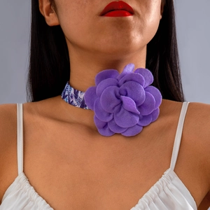 Close-up of a purple 3D fabric flower choker with tropical leaf print band