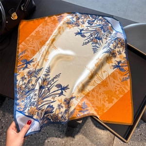 Elegant mulberry silk scarf featuring floral print and orange contrast color splicing