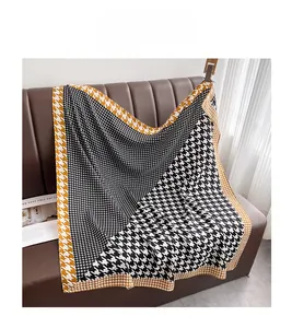 Detail of thin large square scarf with yellow and black houndstooth pattern patchwork