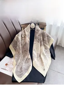 Detail of the high-quality double-stitched edges on the beige floral silk square scarf