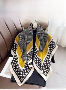 Détail d'un foulard en soie montrant des bords cousus à la machine et motif pied-de-poule