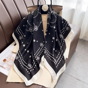 Elegant silk scarf featuring camellia and pearl patterns on a black and white square base