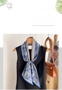 Detail showing paisley print and texture of a faux silk scarf on a handbag